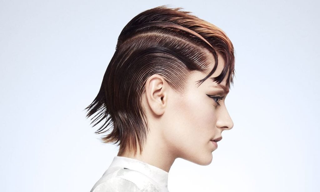 A model from the Resilience by Lucia Siero TONI&GUY collection, showcasing bold hair, vibrant colors, and confidence.