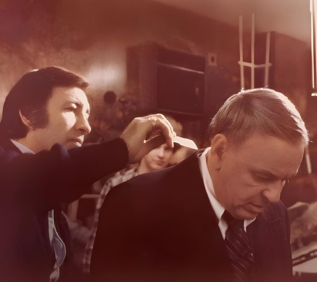 Joseph Paris styling Frank Sinatra’s hair, showcasing his precision and artistry, as featured in The Hair Magazine.