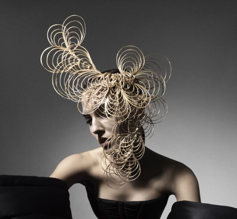 Digital magazine cover featuring the RIZOMA Collection with flowing, organic silhouettes and polished textures inspired by rhizome-like forms; model styled in multidirectional, root-inspired hair design; cover branded with The Hair Magazine – thehairmag.com.