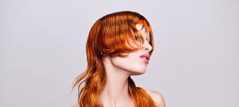 VERTIGO hair collection look with vertical sculptural shape, precise graphic cut, airy texture, and blonde tones with magenta accents